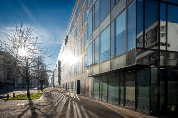 Gennevilliers, France - 01 13 2025: View of a Glass facade of a building and reflections of the sun...