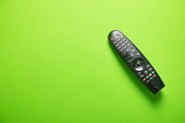 TV remote controller on the green background.