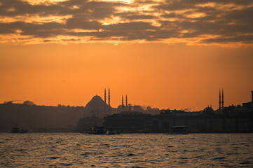 Fototapeta premium Beautiful view of the Bosphorus and the mosque in the background at sunset. View of Fatih district