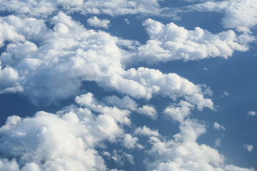   White cumulus fluffy clouds wallpaper taken from the plane in a blue sky good weather day