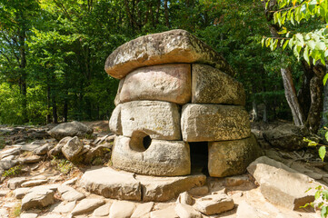 Archaeological site of dolmen or ancient burial and cult structure is located in the forest. Stone...