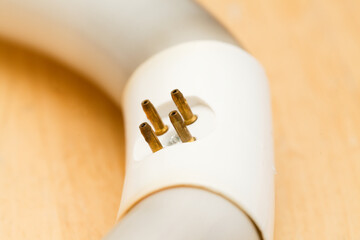 Circular fluorescent tube burned out and blackened at the cathodes, contact pad prongs oxidized