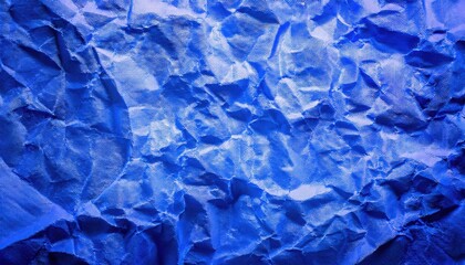 Obraz premium textured close-up of crumpled blue paper with intricate folds and shadows, ideal for background, design projects, or graphic art use