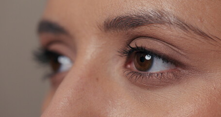 Fototapeta premium Quick video of a girl looking to the side, blinking with her beautiful dark brown eyes.