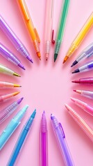 Colorful Pens Arranged in a Circle on Pink Background