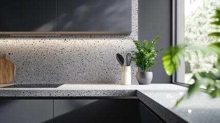 a gray kitchen with terrazzo countertop and a plant in the corner, gray wall background