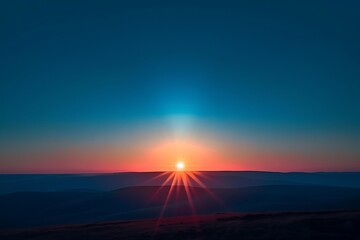 A breathtaking sunset over a vast landscape. The sun dips below the horizon, casting vibrant orange and pink hues across the sky. Sun rays illuminate the distant hills.