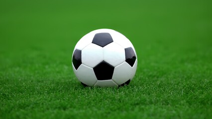 Fototapeta premium soccer ball on stadium Soccer ball skidding across field under stadium lights, capturing the intensity of the game on a rainy night.