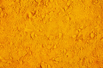Curcuma spice powder as background, top view. Aromatic ground turmeric. Curcuma longa.