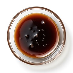Close-Up View of Dark Soy Sauce in a Glass Bowl with Bubbles and Reflections on a White Background for Culinary and Cooking Imagery Usage