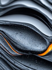 Obraz premium Abstract Dark Gray and Orange Waves - Close-up of abstract dark gray and orange waves with water droplets, creating a modern and sleek design.