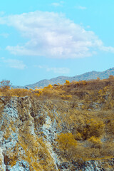 Infrared photography, a rugged landscape featuring steep cliffs and rocky formations