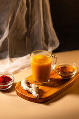 Immunity drink with turmeric powder. Turmeric tea. Trendy healthy drink with curcuma spices. Herbal beverage for health and normal bowel function