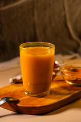 Immunity drink with turmeric powder. Turmeric tea. Trendy healthy drink with curcuma spices. Herbal beverage for health and normal bowel function