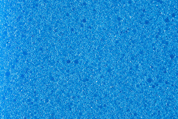 blue background, photo shows texture of blue foam sponge close-up