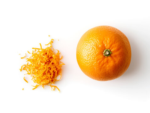 Orange zest and whole orange on white background, showcasing vibrant citrus color and texture ideal for recipes or culinary websites 