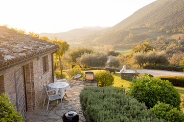 charming rustic house surrounded by lush greenery, overlooking the serene Tuscan countryside....