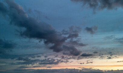 A dramatic sunset with vibrant colors and textured cloud formations, creating a serene yet dynamic atmosphere. Ideal for backgrounds or nature-themed projects.