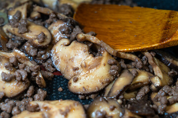 stir-frying the seasoned beef and shiitake mushroom