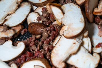stir-frying the seasoned beef and shiitake mushroom