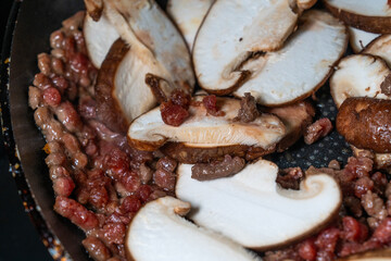 stir-frying the seasoned beef and shiitake mushroom