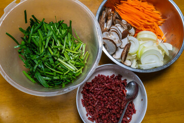 Japchae ingredients of chives, beef, onion, shiitake mushroom, carrot