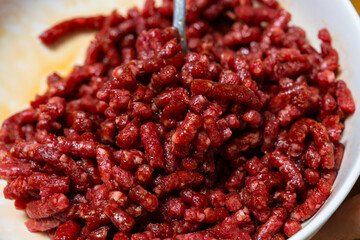 seasoning the beef with soy sauce, cooking oil and sesame sauce