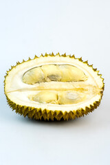Close-up of a sliced durian fruit showcasing its spiky shell and yellow flesh. Highlighting the...