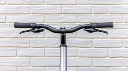 Sleek Bicycle Handlebars Against White Brick Wall