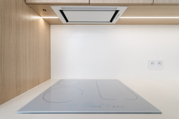 Modern minimalist kitchen with sleek induction stove and smart design