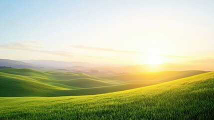 Obraz premium Serene landscape showcasing rolling green hills illuminated by a warm sunrise, perfect for nature-themed projects.