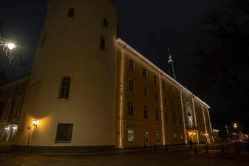 street in old Riga town in night. Yellow castle building
