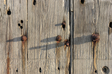 Weathered Harbour Wharf Wall Wood Plank Texture Background with Rusty Bolts and Holes