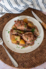 homemade meal of chicken with potatoes and gravy. Cutlery and home table background