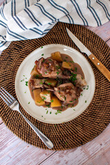 homemade meal of chicken with potatoes and gravy. Cutlery and home table background
