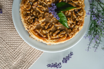 homemade cheesecake with nuts. decorated with flowers on a table at home