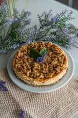 homemade cheesecake with nuts. decorated with flowers on a table at home