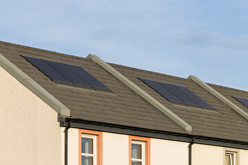 Fototapeta premium Solar PV Panels on Residential Roof of Modern Apartment House with Energy Efficient Design
