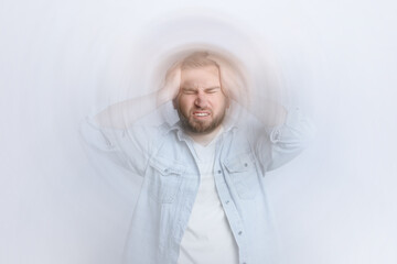 Man suffering from headache and dizziness on white background