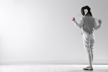Fencer with epee indoors, space for text