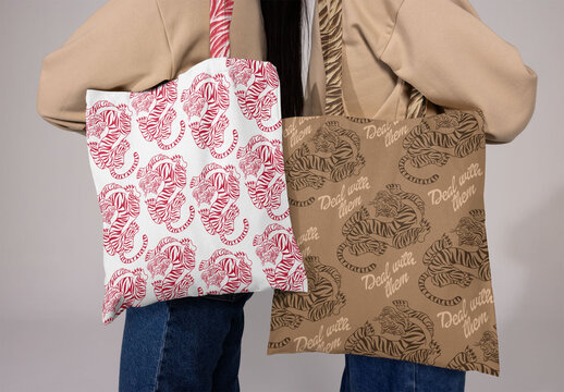 Two blank tote bags are held up, showcasing a perfect canvas for creating custom logos and designs for any occasion.