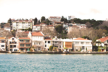 Obraz premium Waterside mansions on the Yeniköy coast. Vintage effect waterside residences. Warm tones. Touristic architectural buildings. 