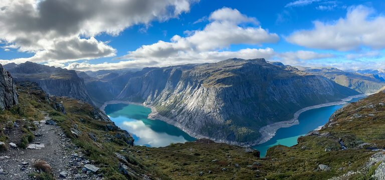 Norway panoramic landscape and beautiful nature in sunny day. Attraction and the most wanted destination in Norway. Trolltuga stone. isit to Trolltunga, a majestic rock formation perched above serene 