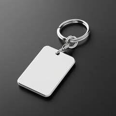 Fototapeta premium Keychain Mockup concept. A silver keychain with a blank rectangular tag on a dark surface, suitable for personalization or branding.