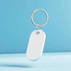 Fototapeta premium Keychain Mockup concept. A simple white keychain tag on a silver ring against a blue background, ideal for labeling or branding purposes.