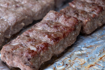 Cevapi on the grill.