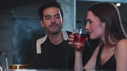 Bartender serving mist smoky classical mixing whiskey with liquor of cocktail to woman tasting with recommending special welcome tasty drink at beverage counter bar to group guests at club. Vinosity.