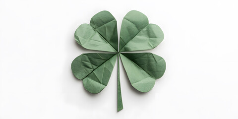 A meticulously folded origami four-leaf clover, crafted from a sage green paper, rests on a pristine white background.  A symbol of luck and good fortune.