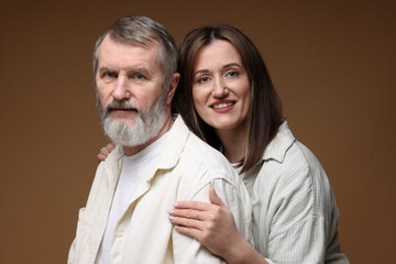 Family portrait of happy daughter and her father on brown background