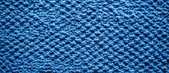 Close-up texture of blue fabric with a raised pattern and copy space for design use